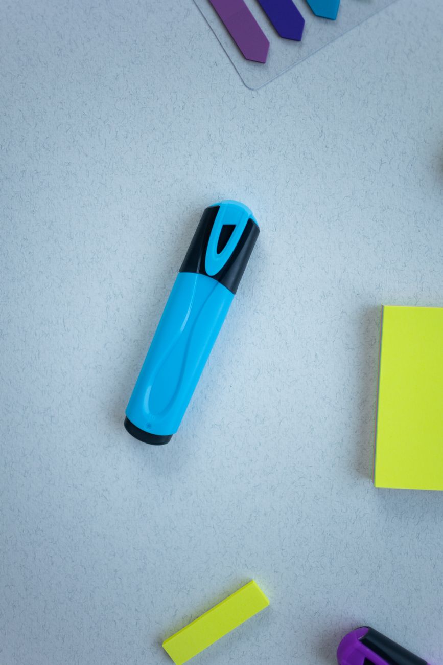 blue marker beside a sticky notes