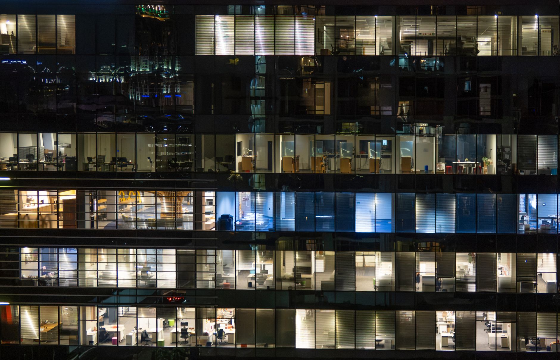 nighttime office building with illuminated floors