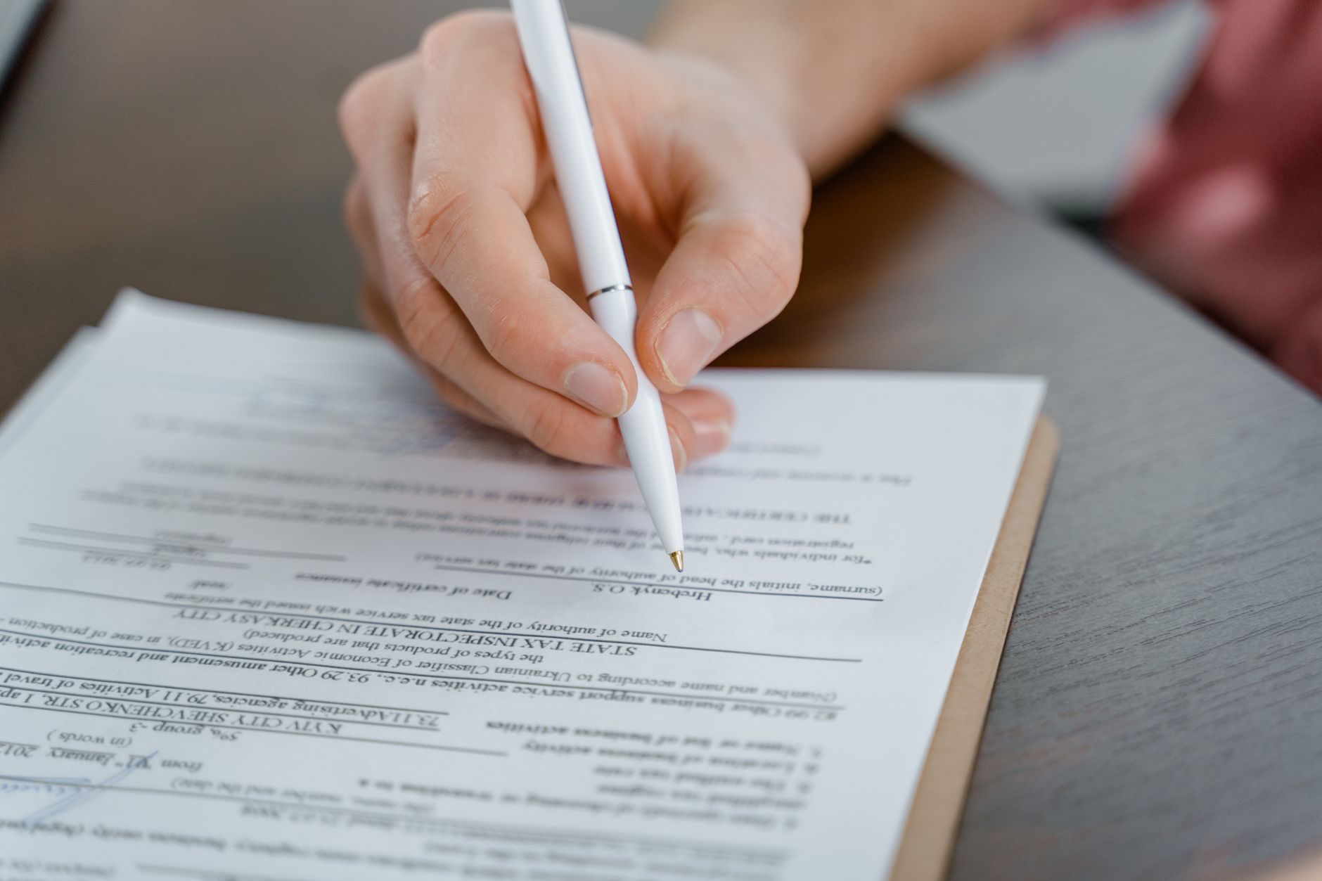 a hand holding a pen