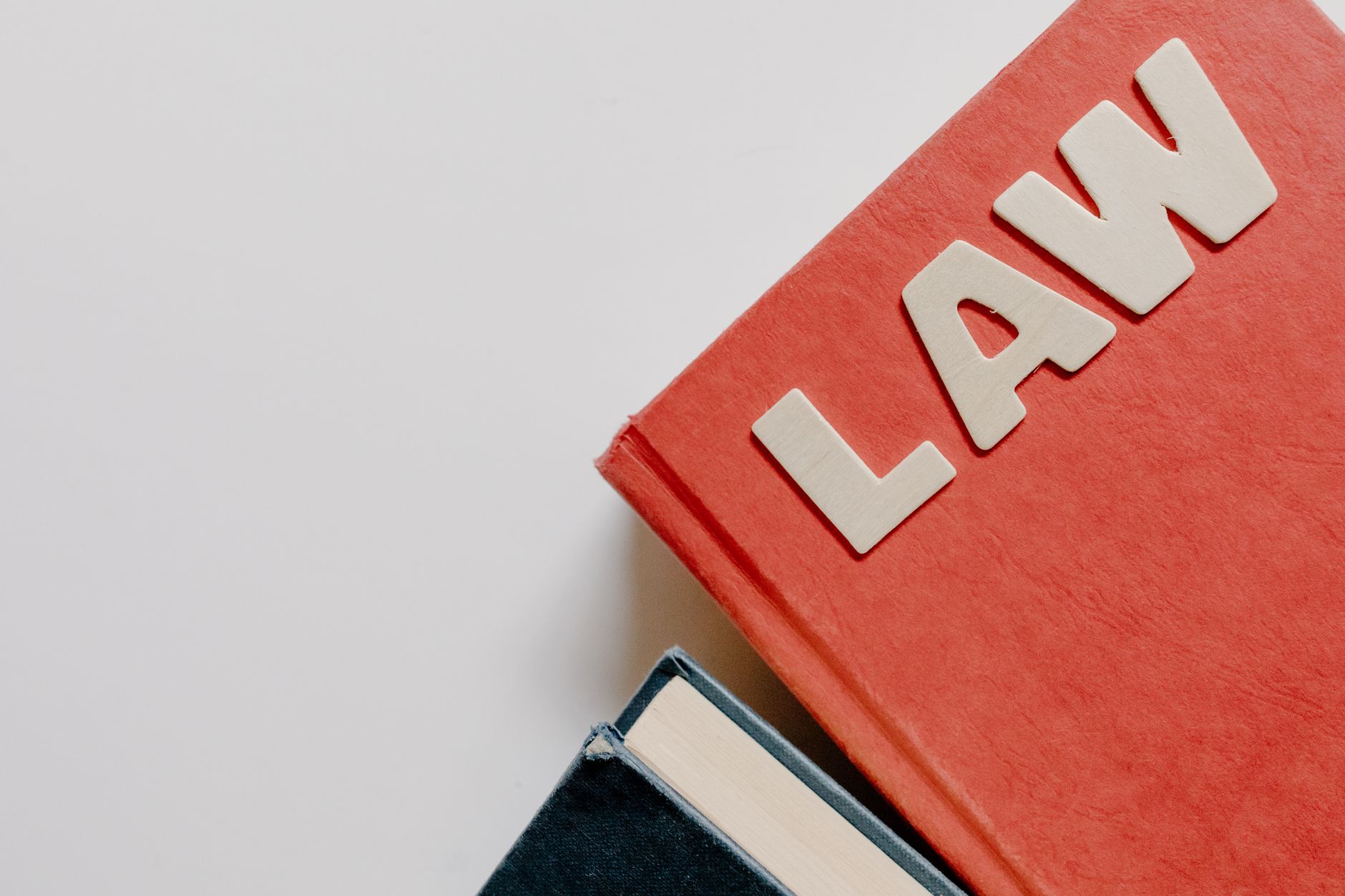 close up of books with a word law on the top