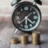 stacks of coins and an alarm clock