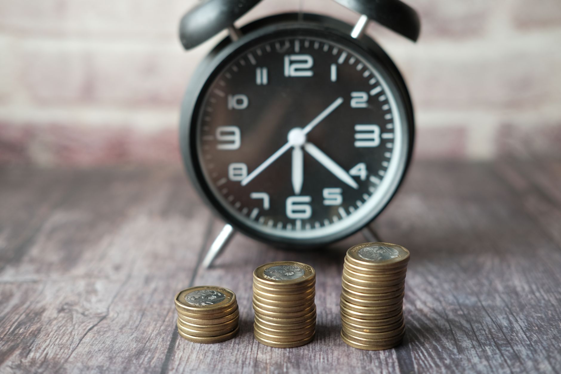 stacks of coins and an alarm clock