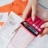 a close up shot of a person using a calculator