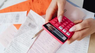 a close up shot of a person using a calculator