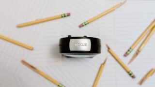 alarm clock and pencils on white background