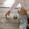 child putting coins into glass jar
